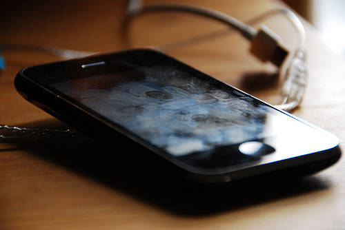 an iPhone has numerous fingerprints and more on its screen and needs cleaning