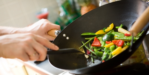 stir fry vegetables being cooked in a wok