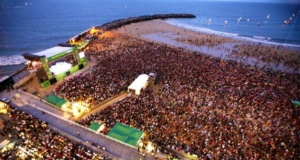 music stage on a beach with big crowd